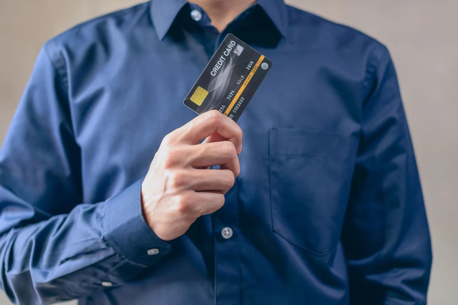 Person comparing multiple business credit cards while researching on mobile device